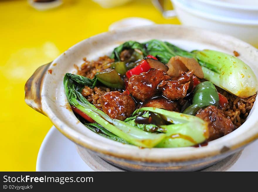 Vegetarian oriental sweet and sour pork dish prepared in traditional claypot. Suitable for food and beverage, healthy lifestyle, and creative food. Vegetarian oriental sweet and sour pork dish prepared in traditional claypot. Suitable for food and beverage, healthy lifestyle, and creative food.