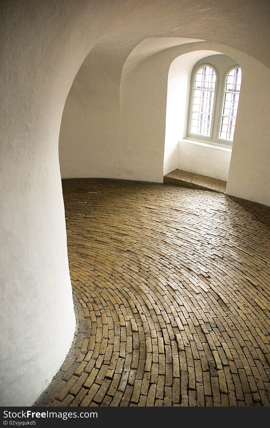 Historical spiral hallway with brick floor