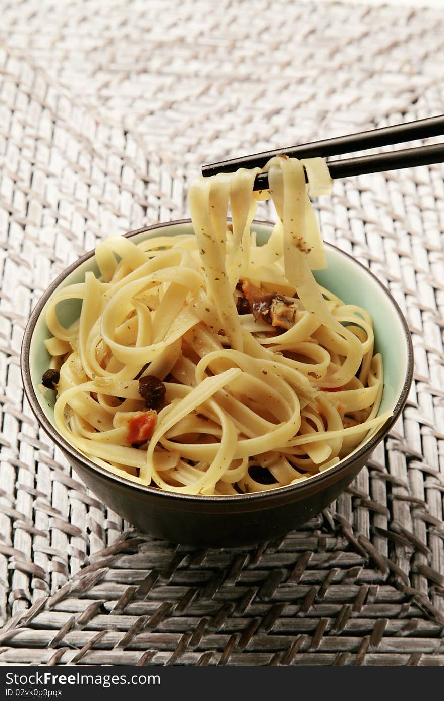 Oriental noodles bowl and chopsticks