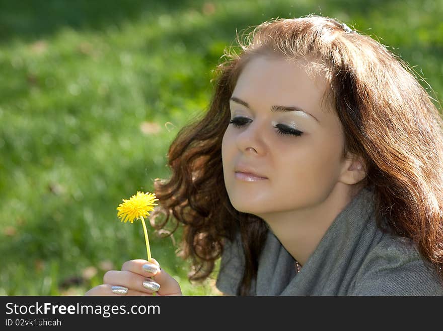 The young woman smiles outdoor