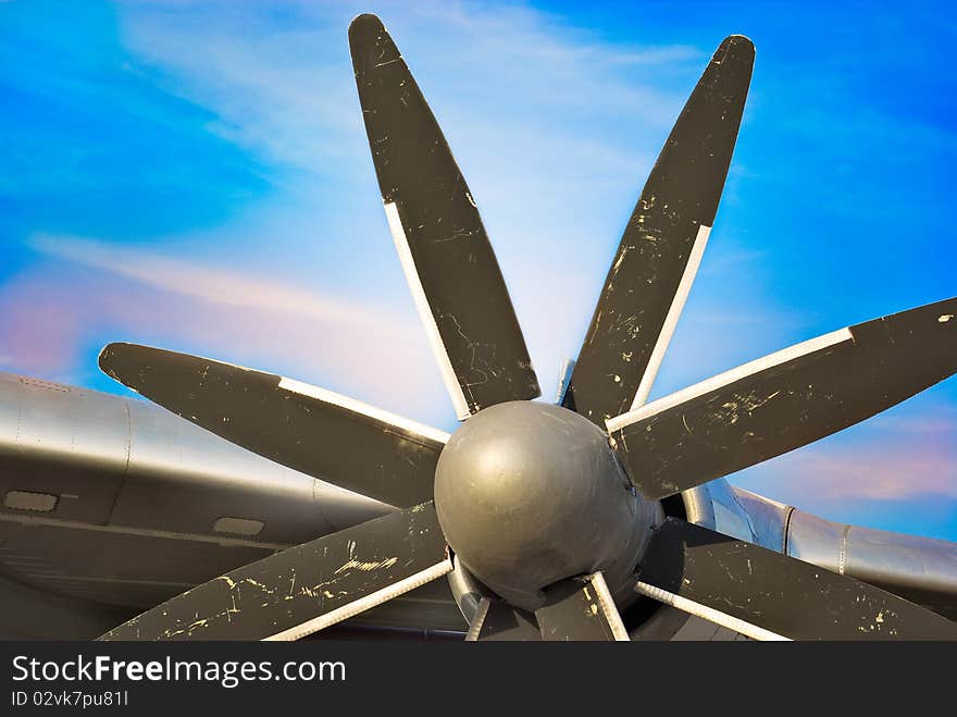 Plane Motor with Propeller and air intake against blue sky