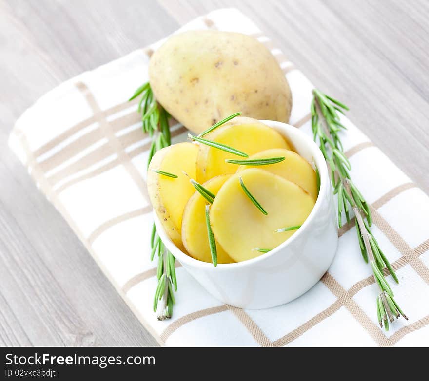 Potato in bowl with rosemary