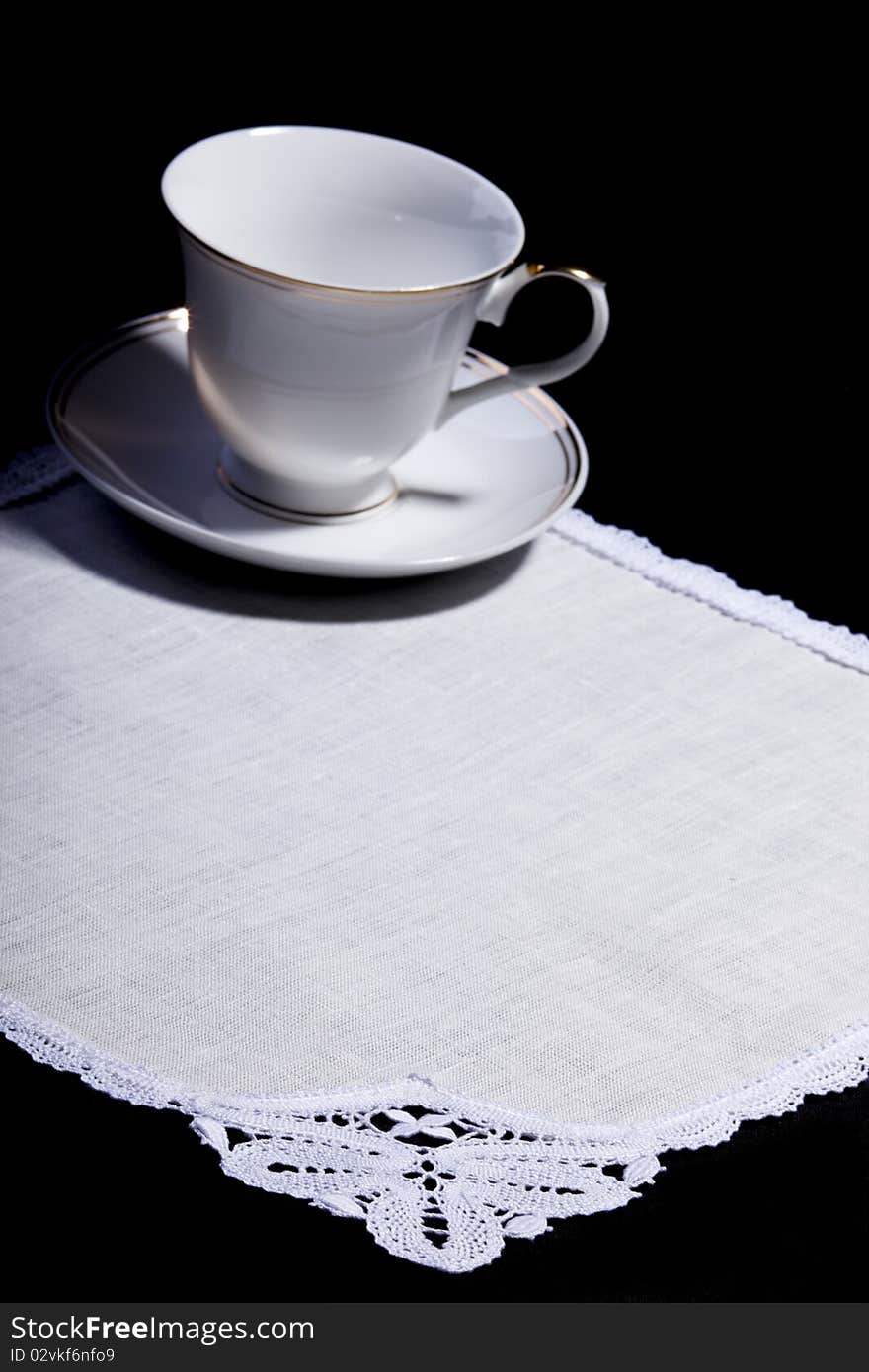 Cup On White Doily