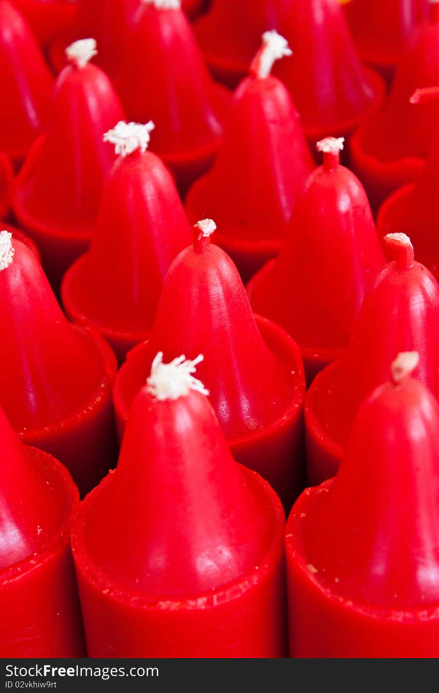 Red candles are used for Buddhist rituals. A religious figure. Red candles are used for Buddhist rituals. A religious figure.