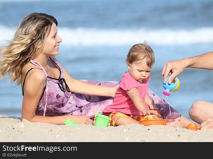 The family plays together on the beach