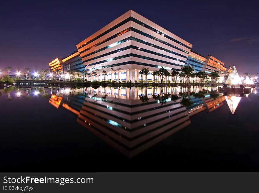 Reflection of Government Complex Building shines at Dusk in Bangkok Thailand.