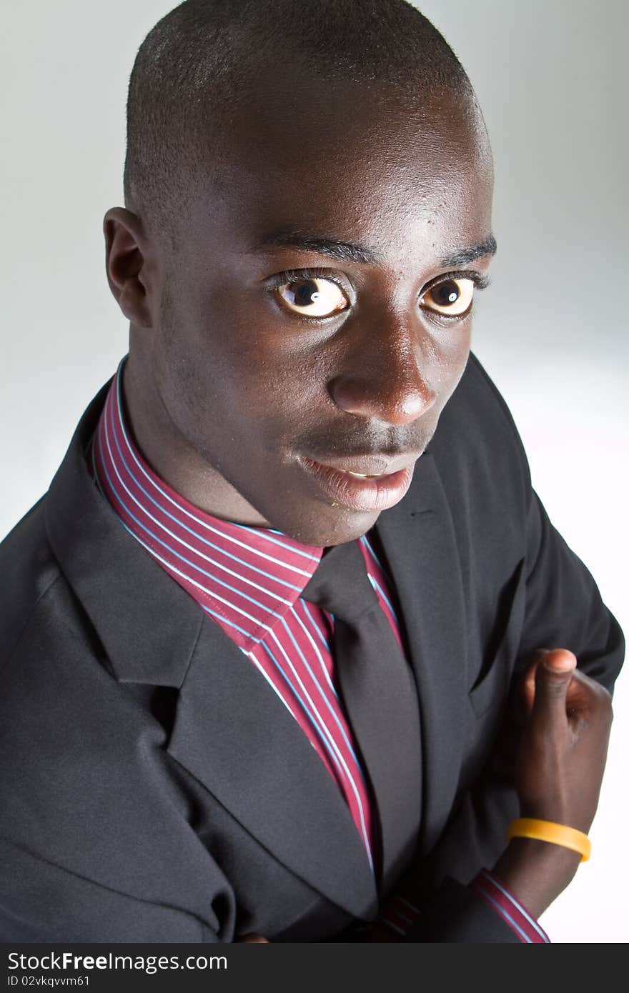 Young black businessman over white background. Isolated fresh teenager in suit.