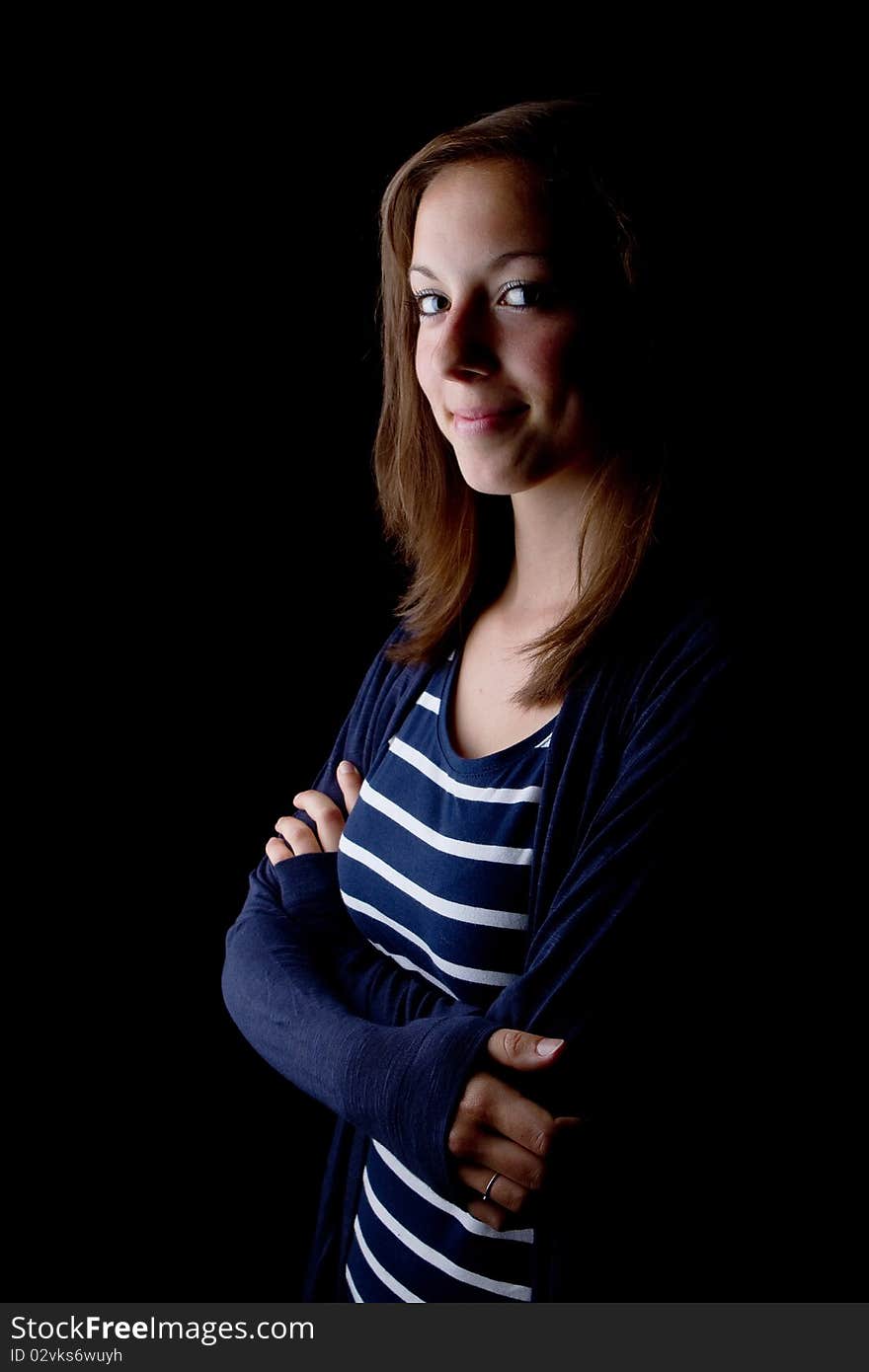 Young fresh teenage girl. Isolated over a black background