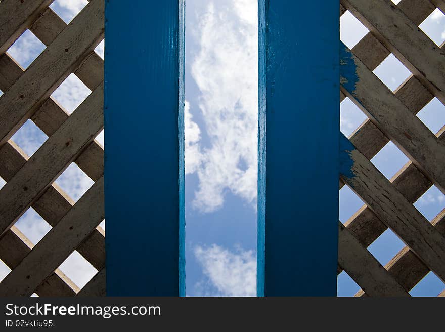 Blue sky with clouds through an aperture in a roof