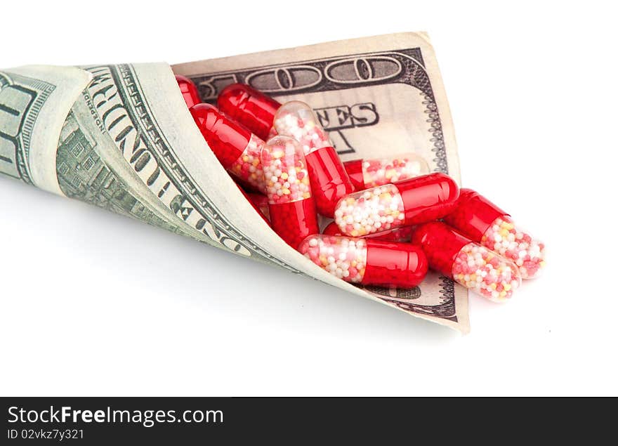 Money and pills isolated on a white