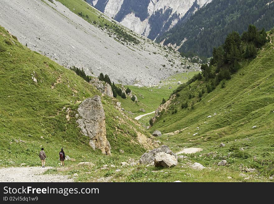 Two hikers travel the roads of the National Park of La Vanoise. Two hikers travel the roads of the National Park of La Vanoise