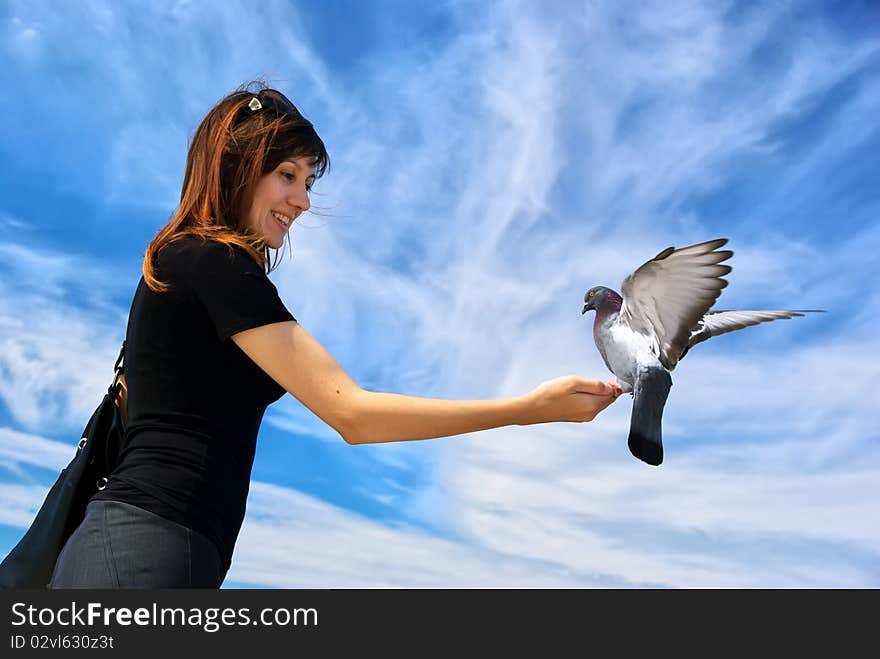 Girl feeds the dove. Element of design.