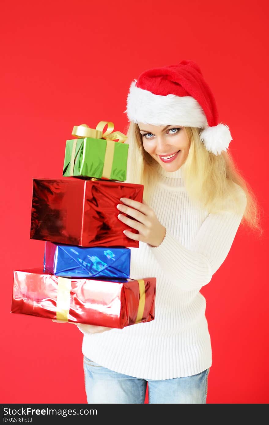 Santa girl with presents on red background