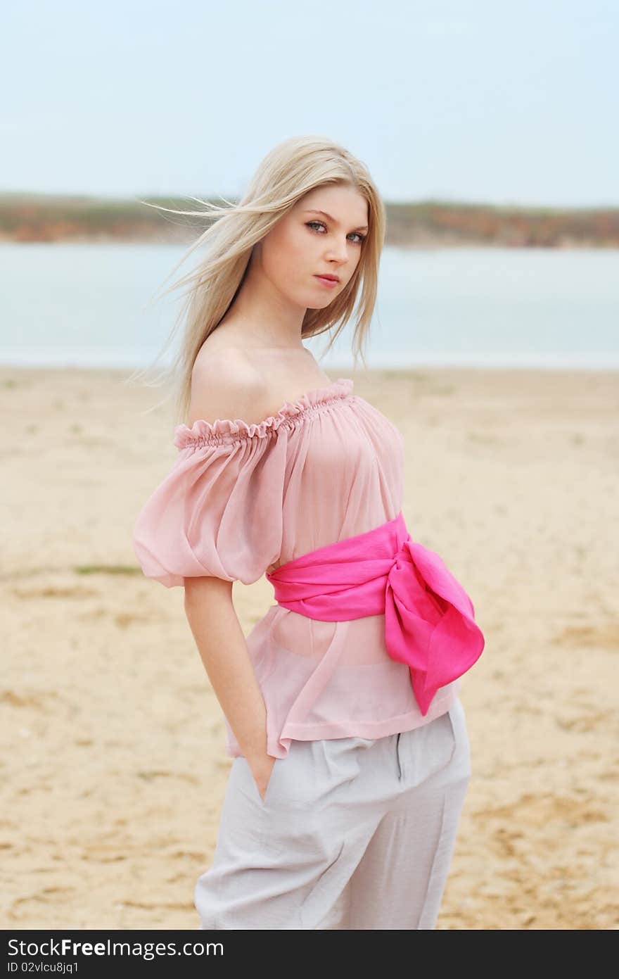 Blond girl near the water