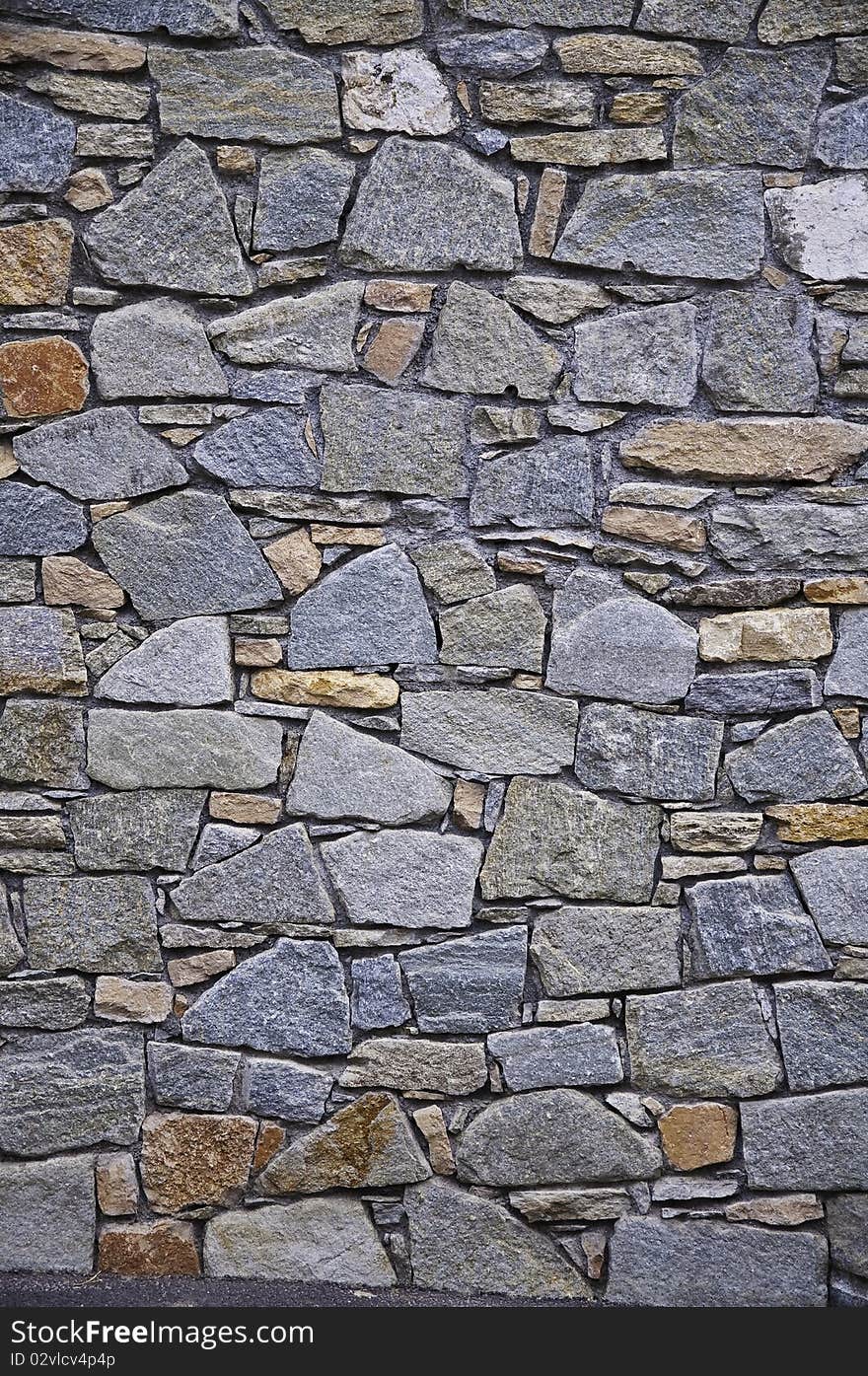 This image shows a wall built with stones. This image shows a wall built with stones