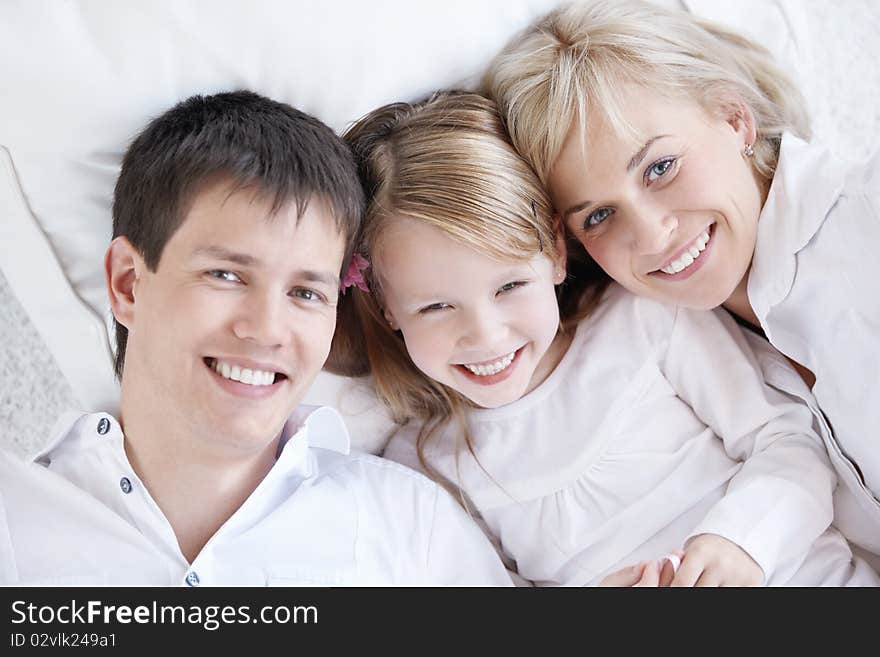 Parents and child in a white close-up. Parents and child in a white close-up