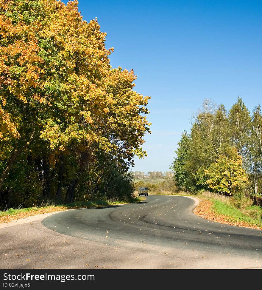 Old car on autumn rural road