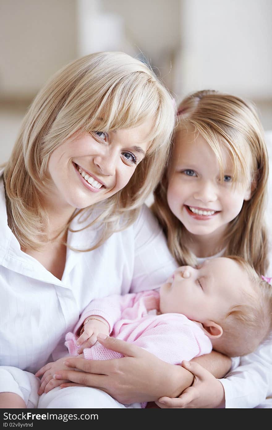 Mom holding the baby in her arms and her daughter. Mom holding the baby in her arms and her daughter