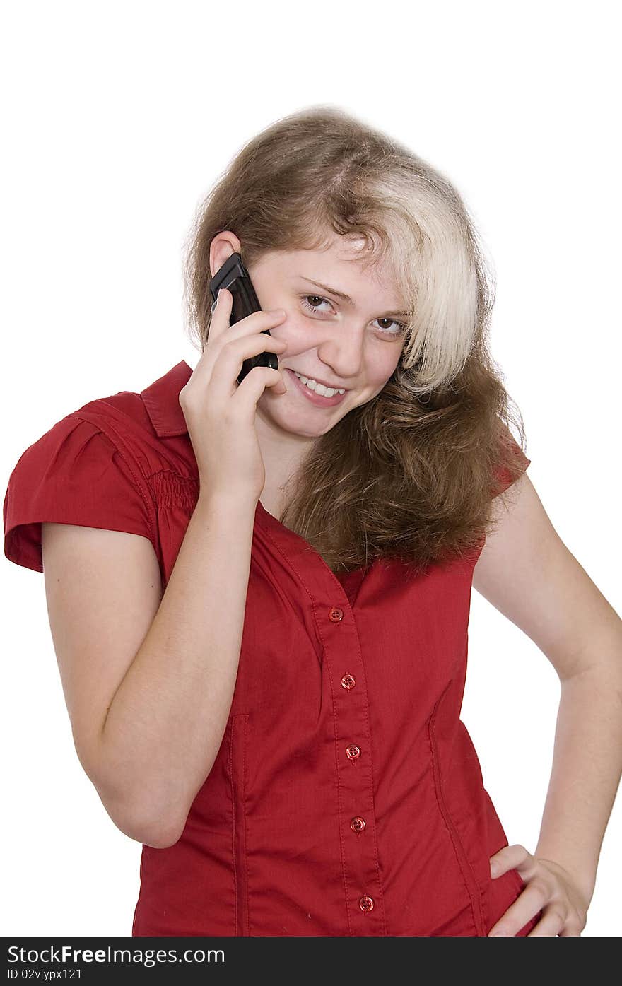 Beautiful young girl in red with a mobile phone isolated over white