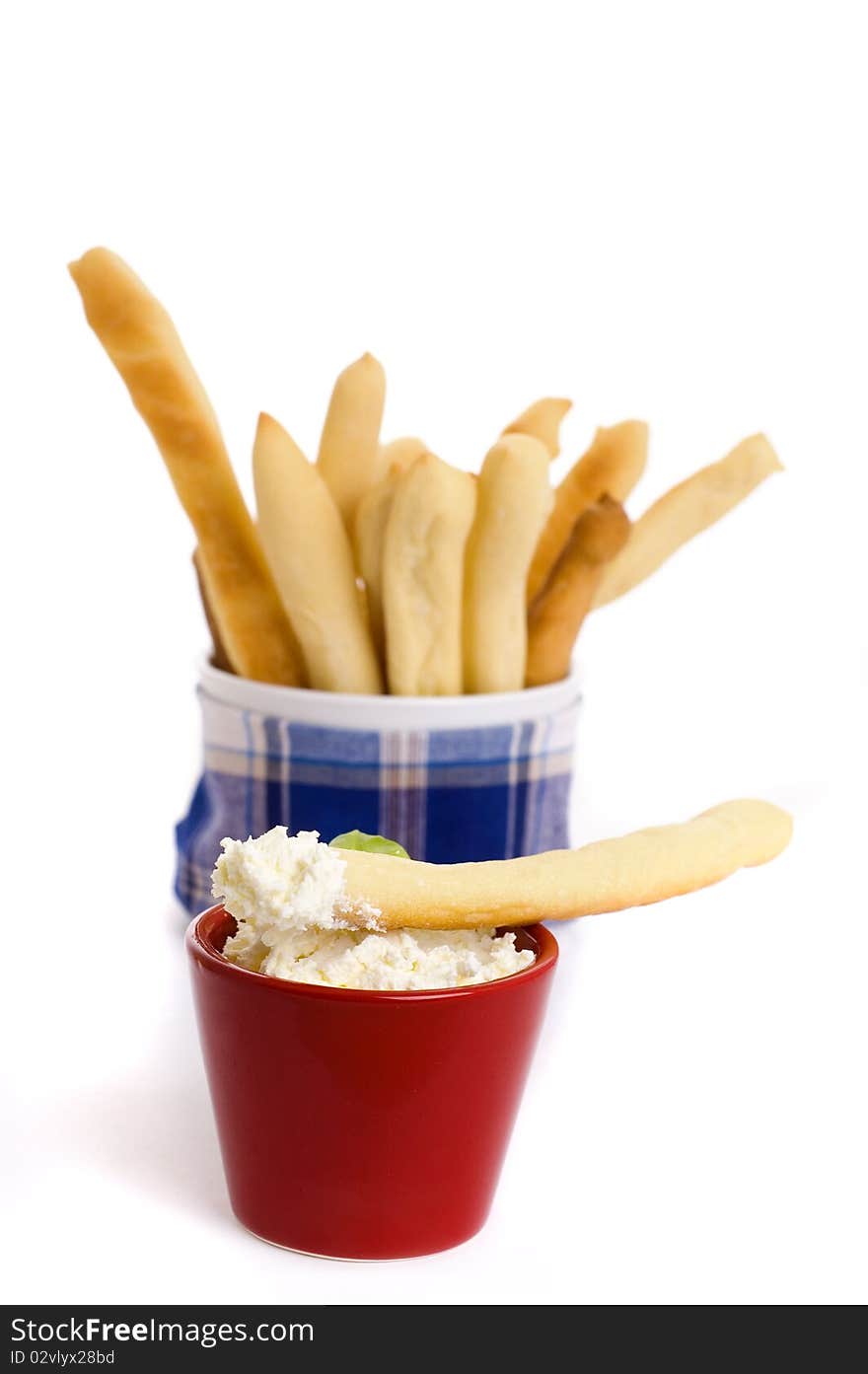 Cream cheese and bread sticks isolated on white background