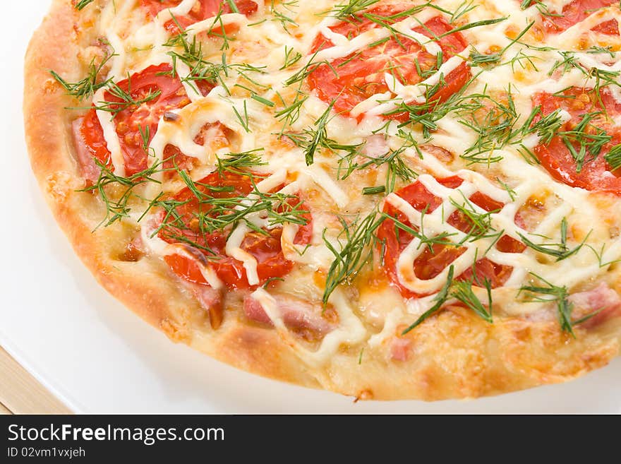 Close-up prepared pizza with tomatoes on plate. Close-up prepared pizza with tomatoes on plate