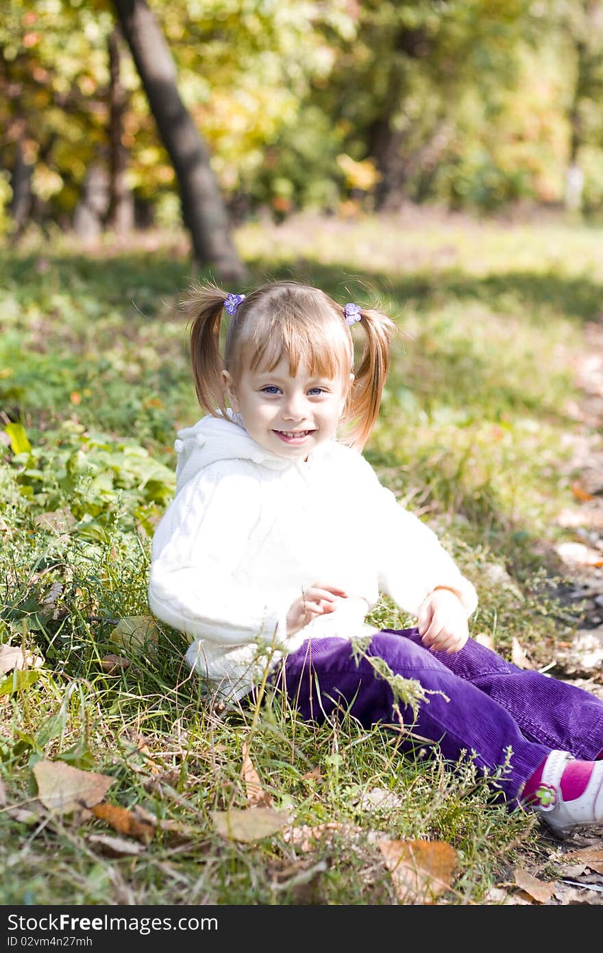 Little girl playing in autumn park. Little girl playing in autumn park