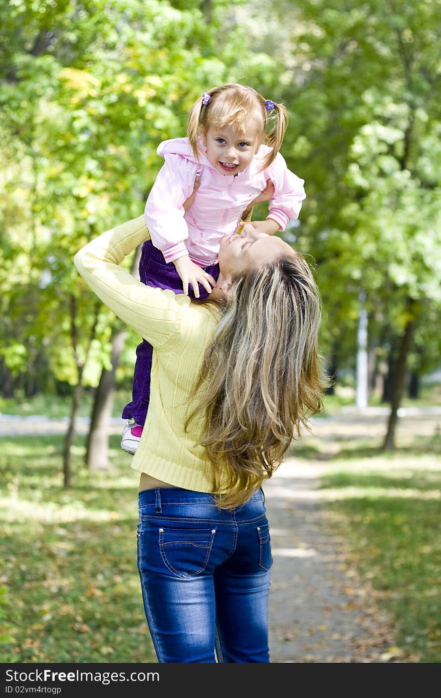 Girl And Her Mother In Autumn Park