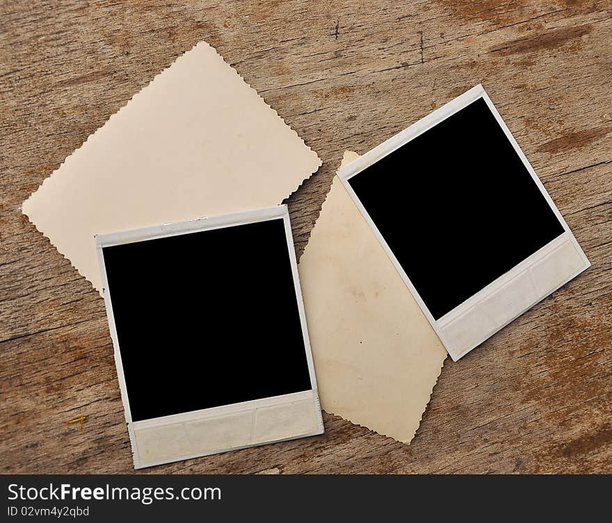 Vintage blank photo frame on wooden background