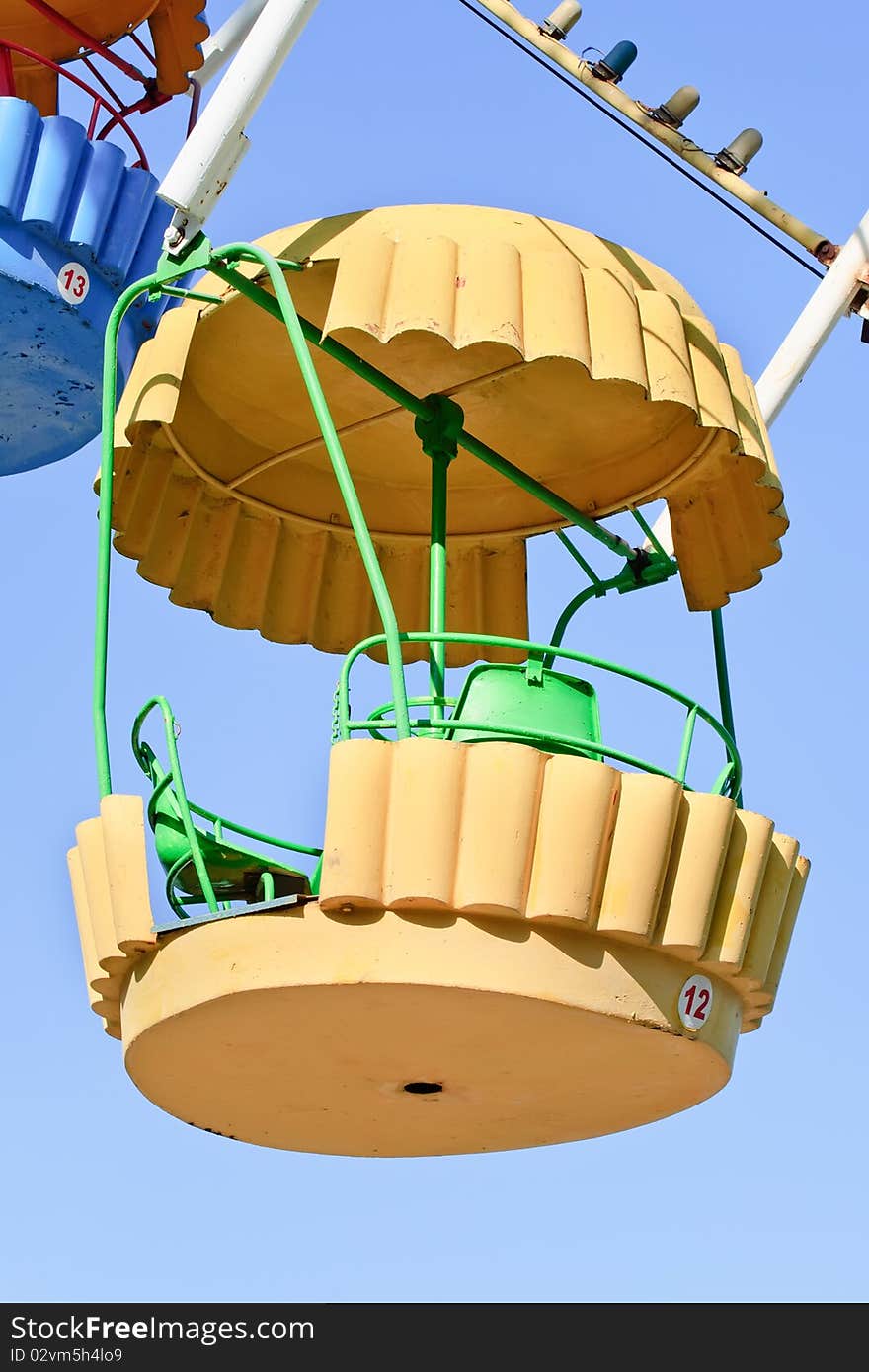 Ferris wheel cabin on a blue sky background