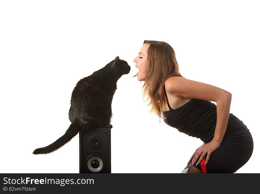 A black cat looks into the girls mouth. A black cat looks into the girls mouth