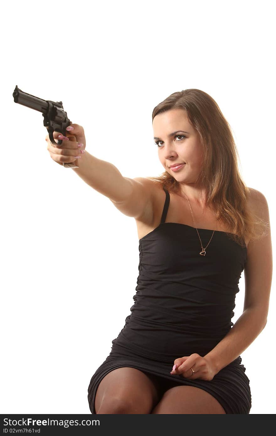 Beautiful young girl is aiming a revolver