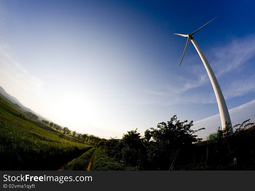 Wind turbine on the meadow shown by fisheye lens. Wind turbine on the meadow shown by fisheye lens