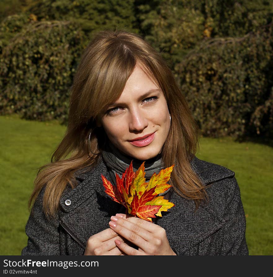 Beautiful girl holding autumn leaves. Beautiful girl holding autumn leaves