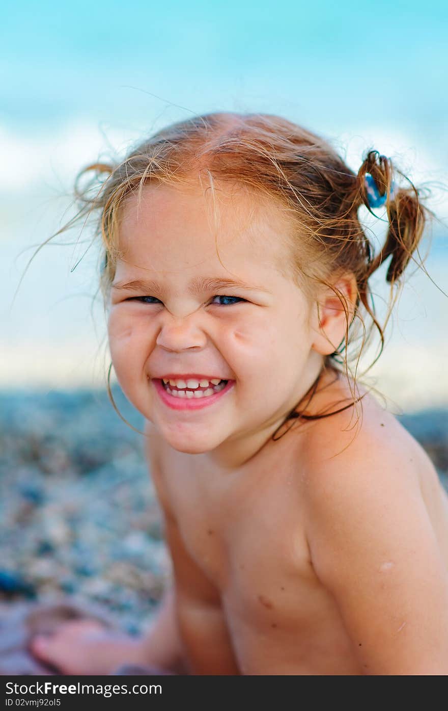 Cute toddler girl on sea background