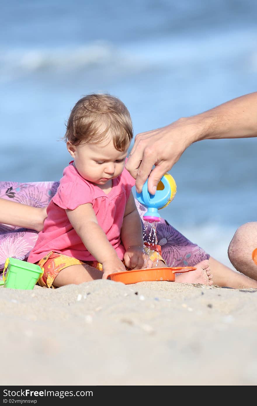 Child is playing in the sand