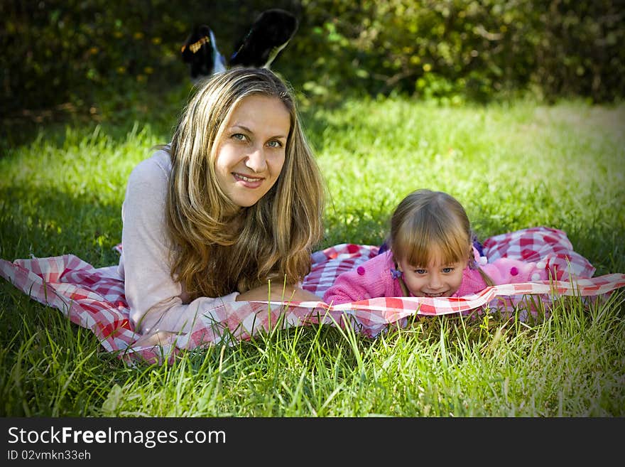 A little girl with her mother in the garden