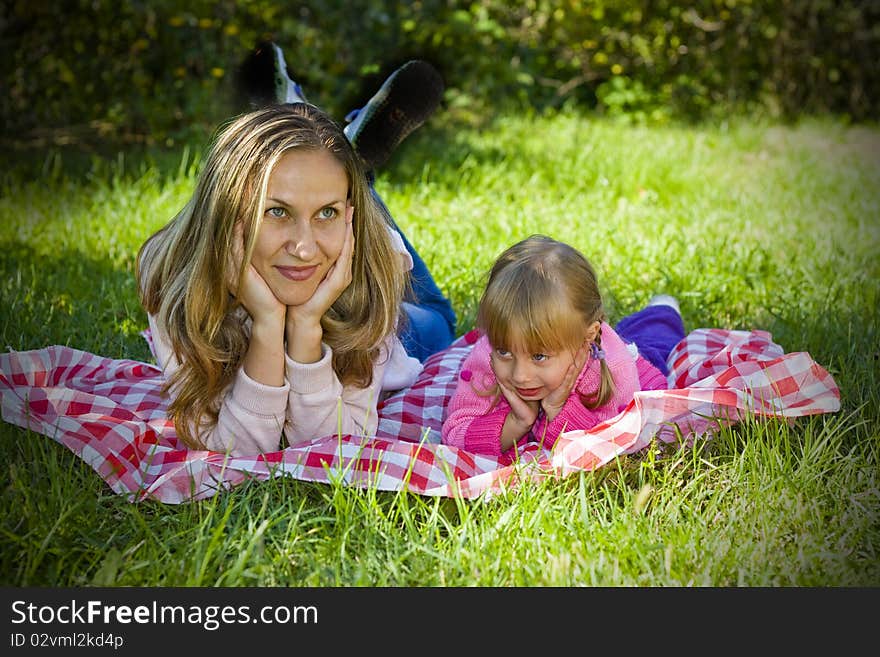 A little girl with her mother in the garden