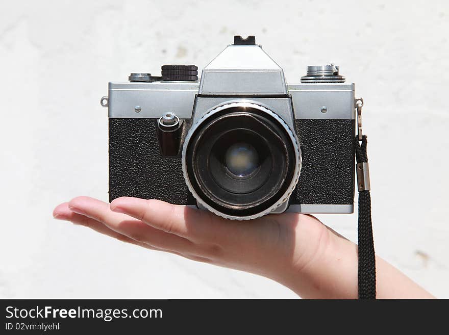 Old Praktica camera held in the palm of a hand