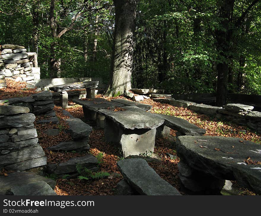 Stone seats and tables of the fregee a typical crotto in the mountains over Chiavenna (Italy)