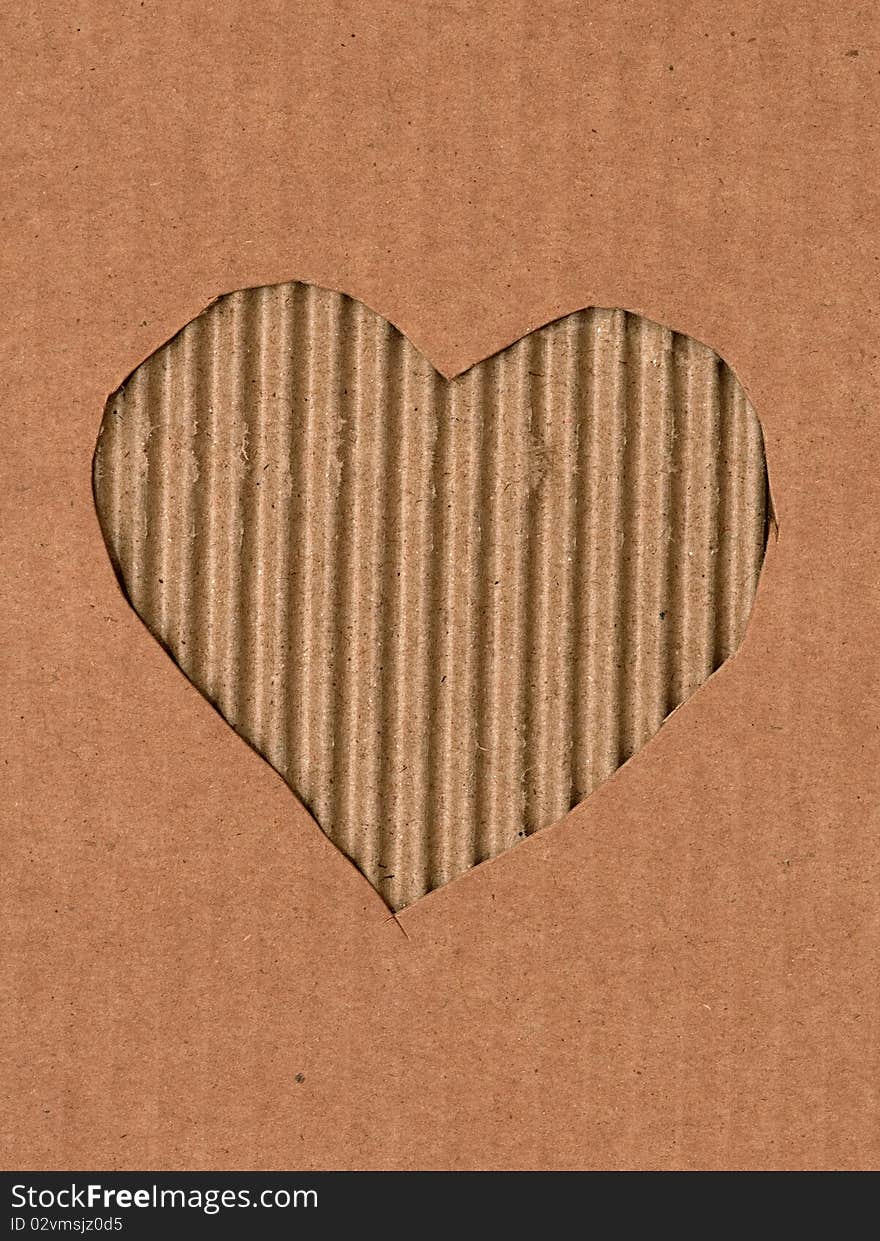 A heart is intagliated from a cardboard. A heart is intagliated from a cardboard