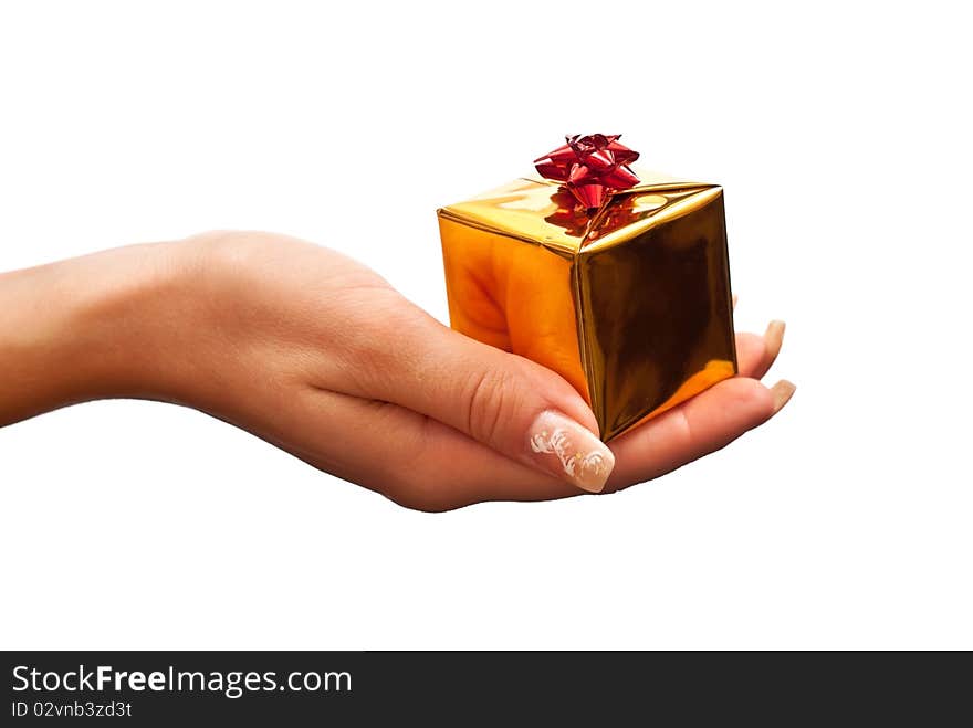 Woman's hand with a small gold gift box with red bow isolated on white background. Woman's hand with a small gold gift box with red bow isolated on white background