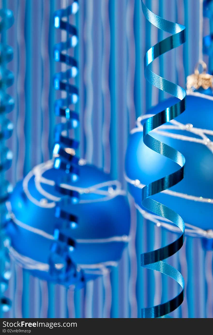 Christmas decoration from two blue balls and ribbons. Focus on ribbon. Christmas decoration from two blue balls and ribbons. Focus on ribbon