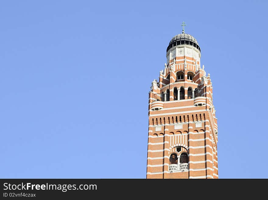 Vertical church tower against blue sky