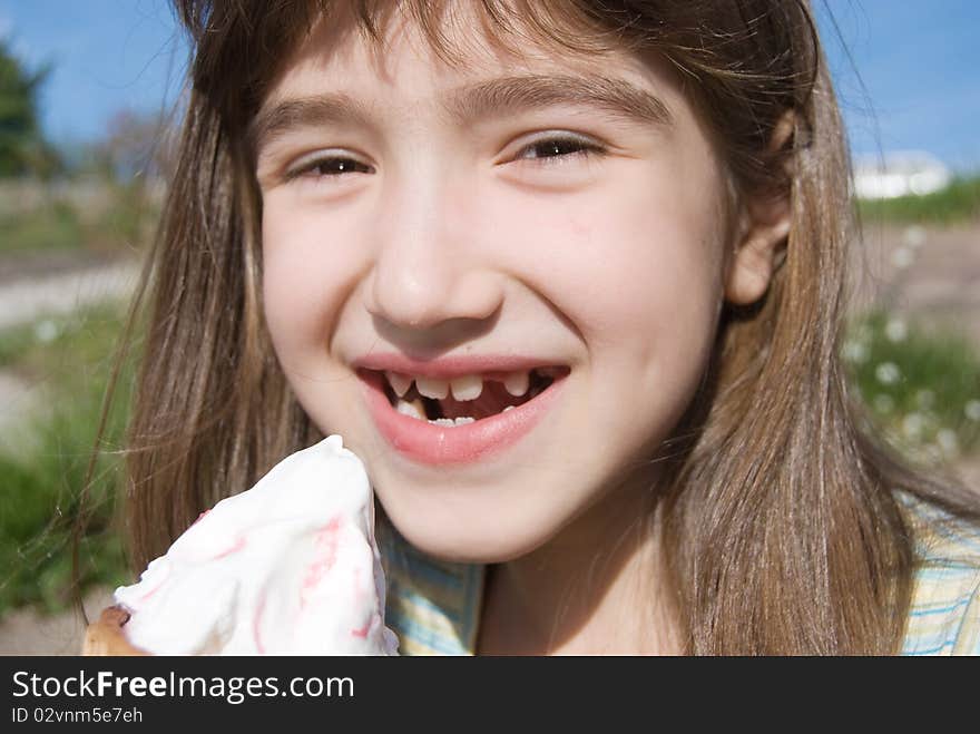 Smiling girl with big ice-cream, outside location