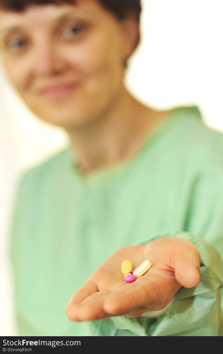 Woman holds pills in a hand