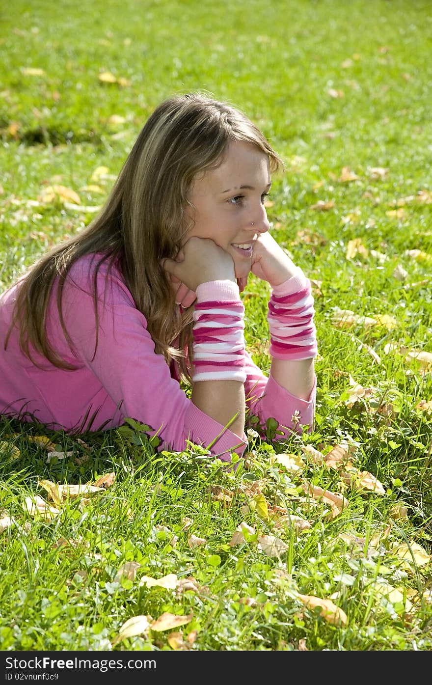 Cute young girl is posing in grass. Cute young girl is posing in grass