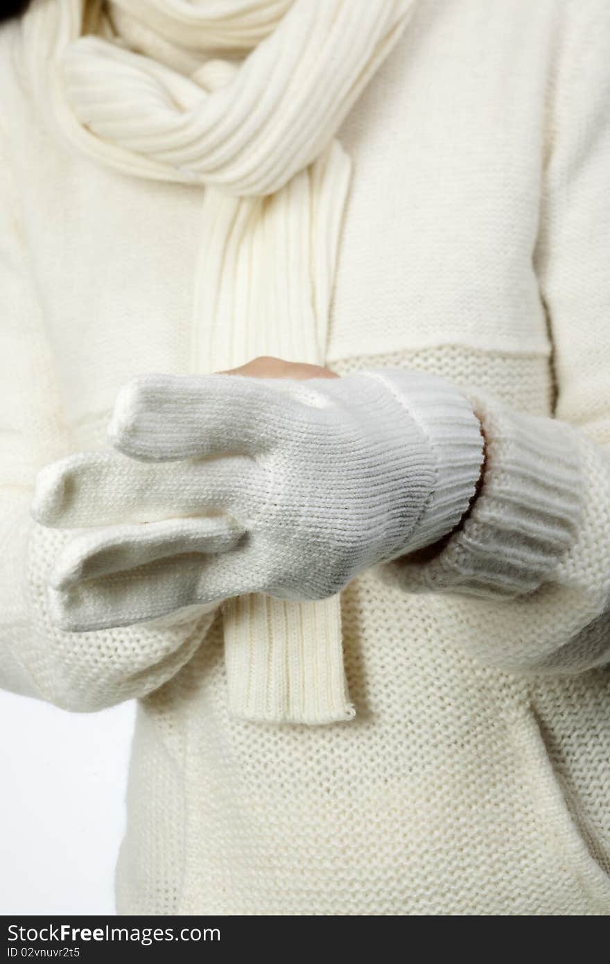 Young woman in soft white sweater, wearing mittens. Young woman in soft white sweater, wearing mittens