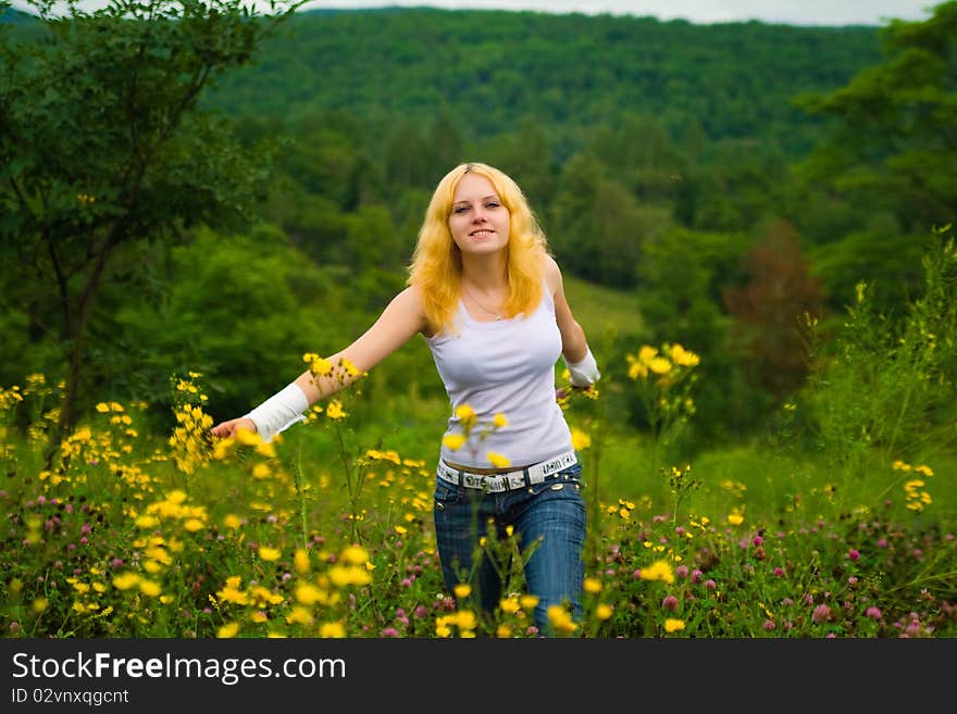 Girl, yellow flowers and grass. Girl, yellow flowers and grass