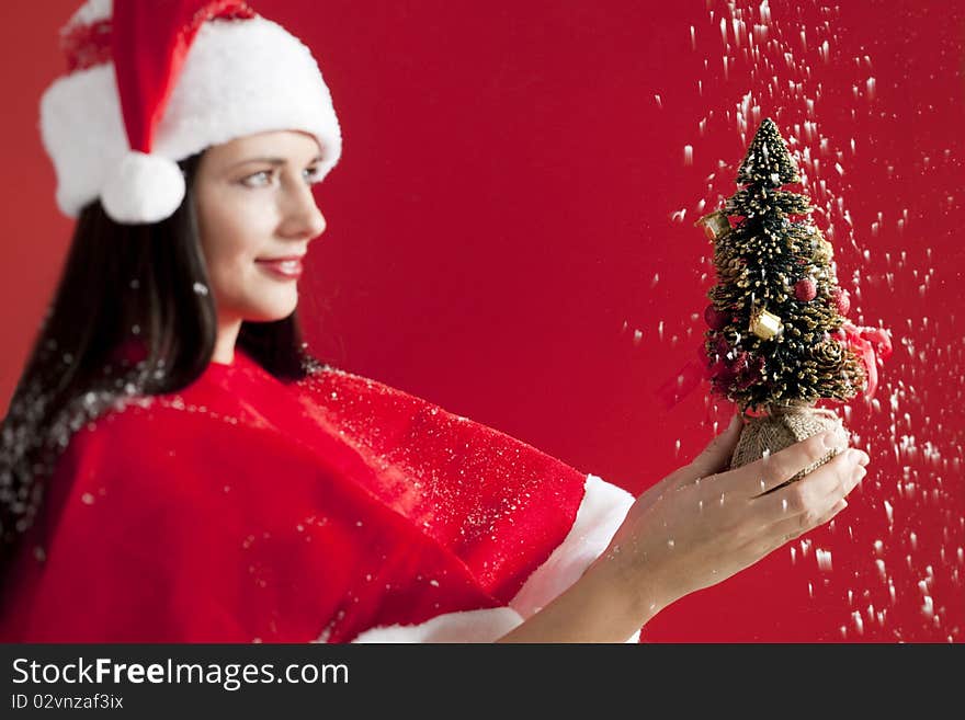 Santa Girl Holding A Small Christmas Tree