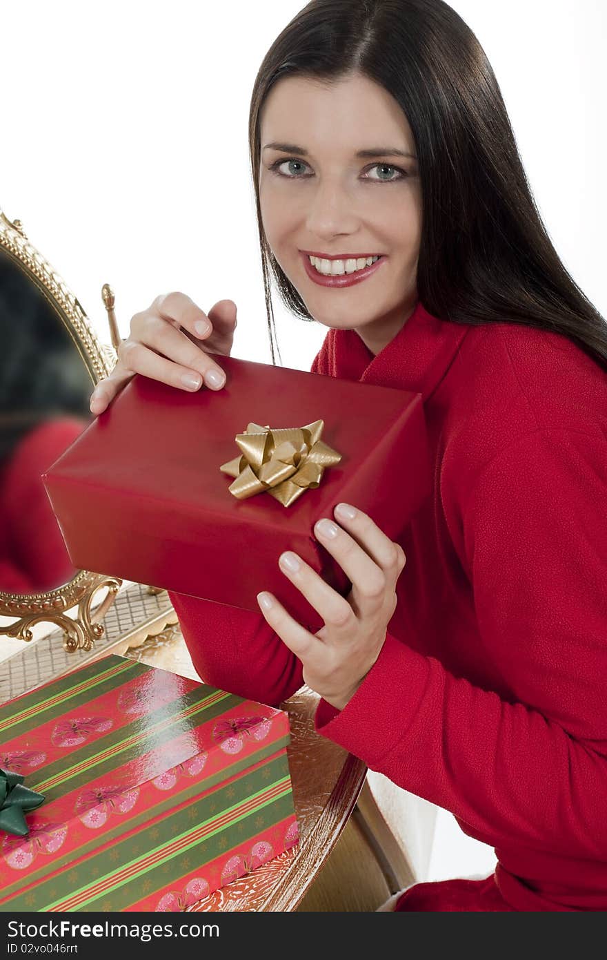 Attractive young woman with Christmas presents against white